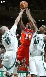 Dee Brown shoots between Michigan State's Drew Neitzel, left, and Idong Ibok, right, during the first half.