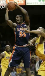 Shaun Pruitt pulls down a rebound over Minnesota forward Bryce Webster, right, during the first half.