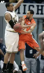Brian Randle passes off against Michigan defender Courtney Sims in the first half.
