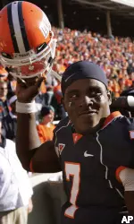 Juice Williams waves to the crowd as he walks off the field after defeating Northwestern. (AP Photo/Brad Vest)