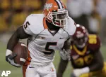 Minnesota defensive end Ray Henderson, background right, looks on as Illinois running back Rashard Mendenhall, left, races 33 yards for a fourth-quarter touchdown. (AP Photo/Jim Mone)
