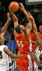 Illinois' Shaun Pruitt shoots over Penn State's Brandon Hassell, left, and Geary Claxton during the first half. (AP Photo/Centre Daily Times, Christopher Weddle)