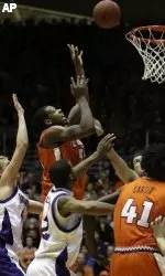 Shaun Pruitt goes up for a shot against Northwestern's Kevin Coble and Sterling Williams during the second half.