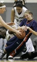 Lori Bjork battles for a loose ball with three Boilermakers.