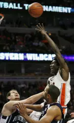 Warren Carter takes a shot over Penn State's Milos Bogetic and teammate Jamelle Cornley during the second half. (AP Photo/Nam Y. Huh)