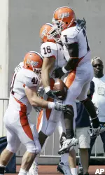 Illinois running back Russ Weil (41), tight end Michael Hoomanawanui (16) and quarterback Juice Williams (7) celebrate a two-yard touchdown reception by Hoomanawanui. (AP Photo/Darron Cummings)