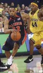 Michigan guard Kelvin Grady defends Demetri McCamey. (AP Photo/Tony Ding)