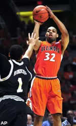 Illinois guard Demetri McCamey (32) puts up a shot over Wofford College guard Cameron Rundles (1). (AP)
