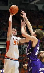 Illinois' Mike Tisdale (54) tries to shoot over Northwestern's John Shurna (24) as Northwestern's Kyle Rowley looks on in the first half of anNCAA college basketball game in Champaign, Ill., on Wednesday, Dec. 30, 2009. (AP Photo/Heather Coit)