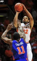 Illinois guard Demetri McCamey puts up a three pointer over Boise State guard Anthony Thomas.