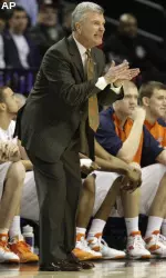 Bruce Weber works from the bench during the first half.
