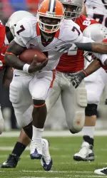 Juice Williams, center, runs for a first down between Ohio State's Brian Rolle, left, and Thaddeus Gibson during the first quarter. (AP Photo/Jay LaPrete)