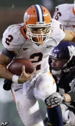 Nathan Scheelhaase (2) is tackled by Northwestern's Vince Browne. (AP)