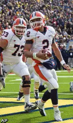 Michigan linebacker Kenny Demens watches Illinois offensive lineman Jack Cornell celebrate quarterback Nathan Scheelhaase's touchdown.