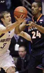 Illinois' Mike Davis, right, passes against Northwestern's Mike Capocci during the first half.(AP Photo/Nam Y. Huh)