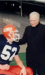 Monsignor Edward J. Duncan, shown here with former Illini John Holocek, former chaplain for Fighting Illini student-athletes and director of the Newman Foundation, passed away Tuesday at the age of 96.