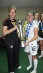 Illinois head coach and U-20 assistant coach Janet Rayfield and Illini and U-20 midfielder Vanessa DiBernardo with the CONCACAF Championship trophy.