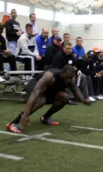 Whitney Mercilus does the 20-yard shuttle as dozens of NFL scouts look on.