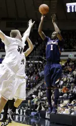 D.J. Richardson shoots over Purdue forwards Travis Carroll and D.J. Byrd.