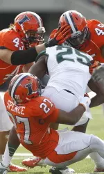 Eaton Spence, Jonathan Brown and Mason Monheim make a tackle.