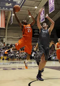 Jan 12, 2014; Evanston, IL, USA; Illinois Fighting Illini guard Tracy Abrams (13) is defended by Northwestern Wildcats center Alex Olah (22) during the second half at Welsh-Ryan Arena. The Northwestern Wildcats defeated the Illinois Fighting Illini 49-43. Mandatory Credit: David Banks-USA TODAY Sports