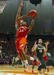 Jan 18, 2014; Champaign, IL, USA; Illinois Fighting Illini guard Tracy Abrams (13) shoots the ball over Michigan State Spartans guard/forward Branden Dawson (22) in the first half of the game at State Farm Center. Mandatory Credit: Trevor Ruszkowksi-USA TODAY Sports