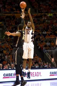 Jan 21, 2015; Champaign, IL, USA; Illinois Fighting Illini forward Leron Black (12) shoots the ball over Purdue Boilermakers forward Vince Edwards (12) at State Farm Center.