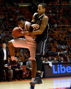 Jan 21, 2015; Champaign, IL, USA; Illinois Fighting Illini forward Leron Black (12) grabs a rebound defended by Purdue Boilermakers forward Vince Edwards (12) at State Farm Center. Illinois beat Purdue 66 to 57.