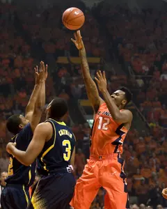 Illinois Fighting Illini forward Leron Black (12) shoots defended by Michigan Wolverines guard Kameron Chatman (3) Mike Granse-USA TODAY Sports