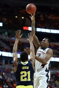 Illinois Fighting Illini forward Leron Black (12) shoots over Michigan Wolverines guard/forward Zak Irvin (21) during the first half in the second round of the Big Ten Conference Tournament at United Center. Mandatory Credit: Jerry Lai-USA TODAY Sports