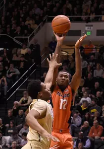 Mar 7, 2015; West Lafayette, IN, USA; Illinois Fighting Illini forward Leron Black (12) shoots over Purdue Boilermakers forward Basil Smotherman (5) in the first half at Mackey Arena. Mandatory Credit: Sandra Dukes-USA TODAY Sports