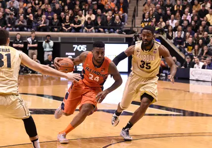 Mar 7, 2015; West Lafayette, IN, USA; Illinois Fighting Illini guard Rayvonte Rice (24) drives to the basket between Purdue Boilermakers guard Dakota Mathias (31) and guard Rapheal Davis (35) in the first half at Mackey Arena. Mandatory Credit: Sandra Dukes-USA TODAY Sports