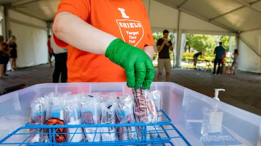 Faculty, staff and students take part in the free on-campus COVID-19 walk-up testing sites on campus. The sites administer an innovative saliva-based test, a process developed by the university’s COVID-19 SHIELD: Target, Test, Tell team. Unlike conventional nasal testing, saliva samples are collected non-invasively, without requiring skilled health care workers. The university started by opening two testing sites: a tent site at the Alice Campbell Alumni Center and an indoor site at State Farm Center. More than a dozen on-campus sites will be added, with a goal to administer 10,000 tests per day by the first day of classes Aug. 24.