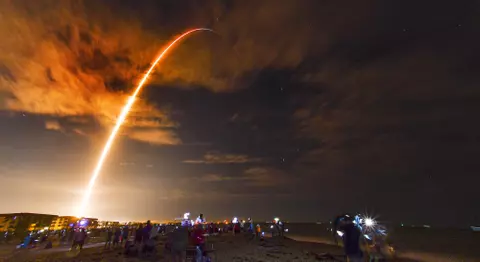 Nov 15, 2020; Kennedy Space Center, FL, USA; Crowds on the beach in Cape Canaveral watch the launch of the SpaceX Falcon 9 Crew Dragon on its Crew-1 mission carrying four astronauts. The rocket was launched from Launch Complex 39A at Kennedy Space Center at 7:27 p.m. Sunday evening. Mandatory Credit: Malcolm Denemark/Florida Today via USA TODAY NETWORK