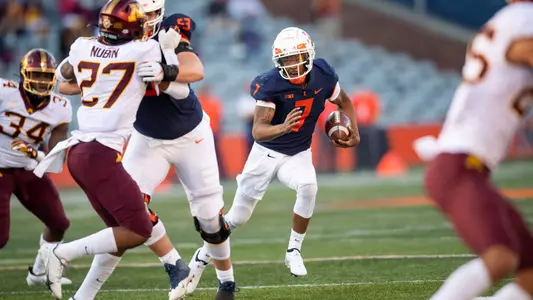 Nov 7, 2020; Champaign, Illinois, USA; Illinois Fighting Illini quarterback Coran Taylor (7) runs the ball against the Minnesota Golden Gophers during the first half at Memorial Stadium. Mandatory Credit: Patrick Gorski-USA TODAY Sports
