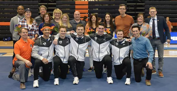 The Seniors of Illinois Mens Gymnastics, pictured with their coaches and families.