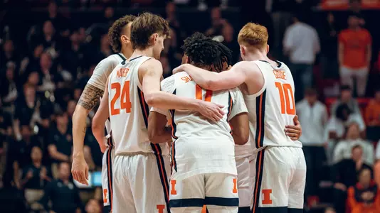 Men's basketball team huddle vs Michigan (Courtney Bay)
