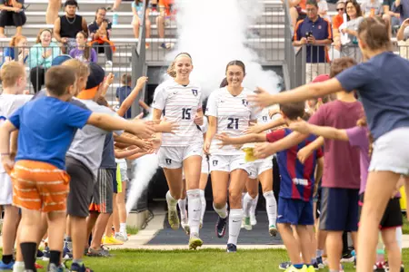 CHAMPAIGN, IL - September 24, 2023 - Illinois Forward Zoey Kollhoff (#15) and Illinois Midfielder Joanna Verzosa-Dolezal (#21) before the match between the Michigan Wolverines and the Illinois Fighting Illini at Demirjian Park in Champaign, IL. Photo By Jenny Butler.