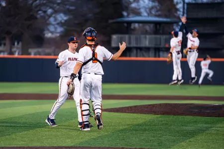CHAMPAIGN, IL - February 27, 2024 - Illinois Left Handed Pitcher Payton Hutchings (#12) and Illinois Catcher Jacob Schroeder (#8) after the game between the Eastern Illinois Panthers and the Illinois Fighting Illini at Illinois Field in Champaign, IL. Photo By Kevin Snyder