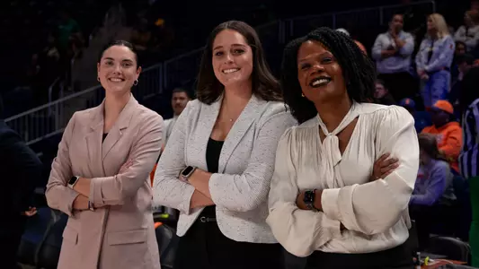 Washington, D.C - November 18, 2023 - Illinois Assistant Coach and Director of Recruiting Operations Emily Durr, Illinois Assistant Coach and Director of Scouting and Player Development Jenna Giacone and Illinois Assistant Coach Britney Anderson during the game between the Notre Dame Fighting Irish and the Illinois Fighting Illini at Entertainment & Sports Arena in Washington, D.C Photo By Madison Dabrowski