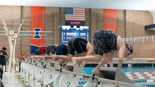 Swimmers about to jump into the pool