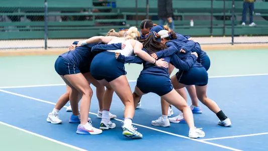 women's tennis team huddle at Big Ten Tournament