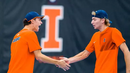 CHAMPAIGN, IL - February 22, 2026 - Gabriel Debru, Tyler Bowers during the match between the North Carolina Tar Heels and the Illinois Fighting Illini at Atkins Tennis Center in Champaign, IL. Photo By Lucas Sun