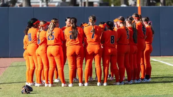Illinois softball huddles on the field
