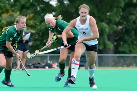 Field Hockey midfielder Caitlin Malone chases ball while being trailed by Vermont defenders during their matchup at Lennon Family Field.