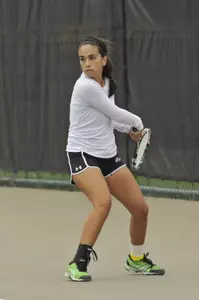 Tennis player Karen Ramirez hits the ball backhand during a match.