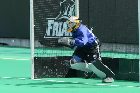 Women's Field Hockey goaltender Deidra Clymer advances out of the goal to defend the ball at Lennon field.
