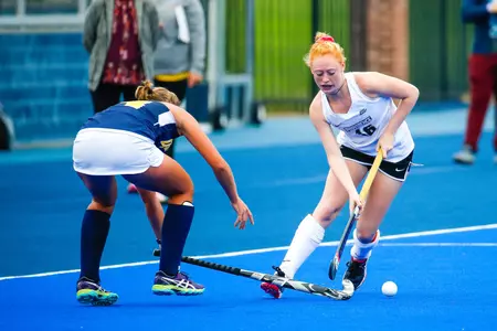 Field Hockey midfielder Mikayla Michals is pictured during gameplay pulling to the right to evade a defender.