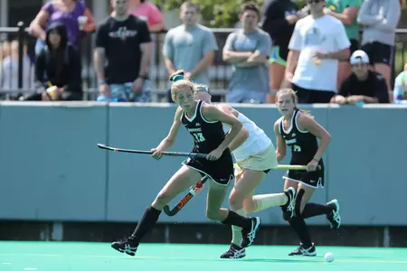 Adrienne Houle chasing down a ball during a field hockey game versus Bryant University at Lennon Family Field