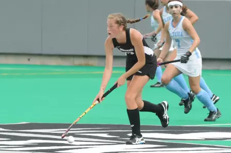 Adrienne Houle dribbles the ball up the field during field hockey game against Columbia